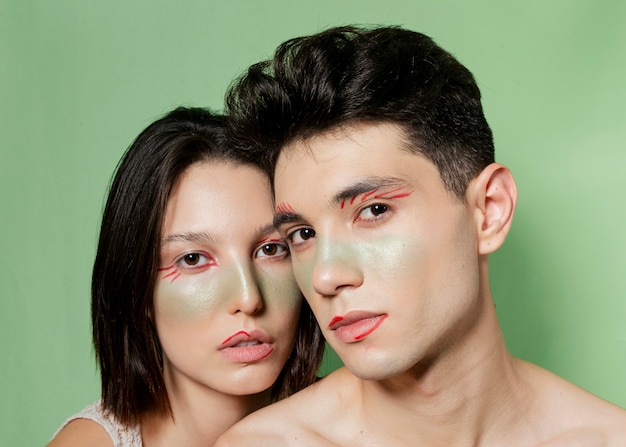 Free photo beautiful couple posing with painted faces