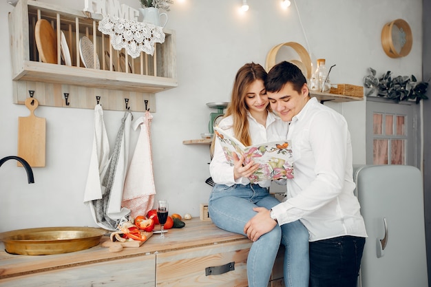 Beautiful couple prepare food in a kitchen