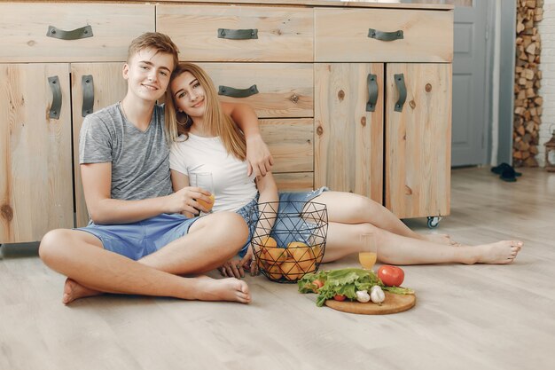 Beautiful couple prepare food in a kitchen