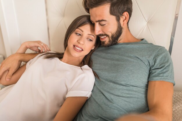 Beautiful couple relaxing on bed