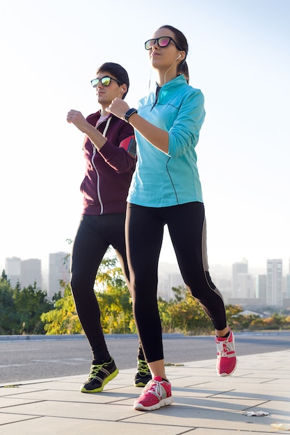 Beautiful couple running in the street.