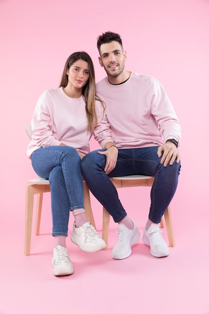 Beautiful couple sitting on chairs