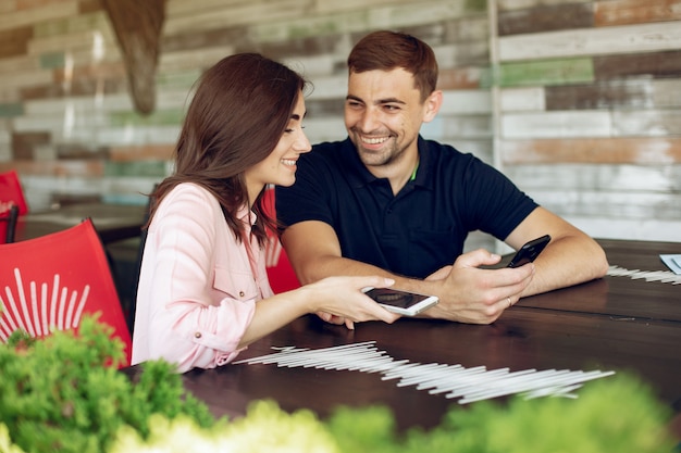 Free photo beautiful couple sitting in a summer cafe