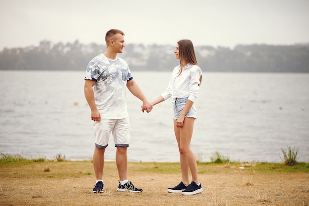 Beautiful couple spend time in a autumn cloudy park