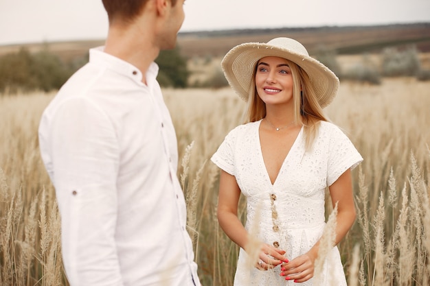 Beautiful couple spend time in a autumn field