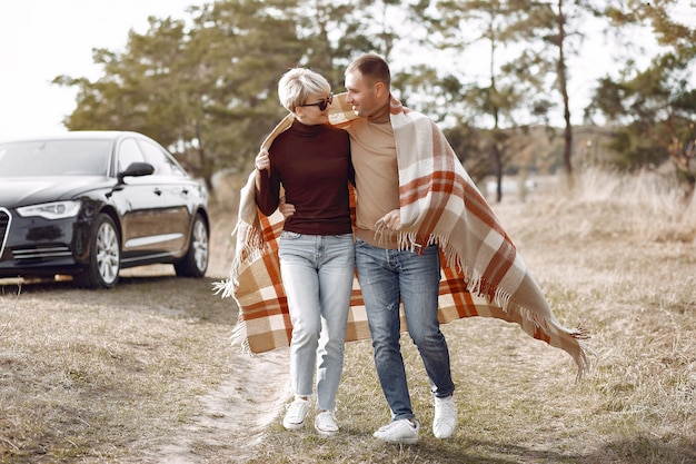 Beautiful couple spend time on a autumn field