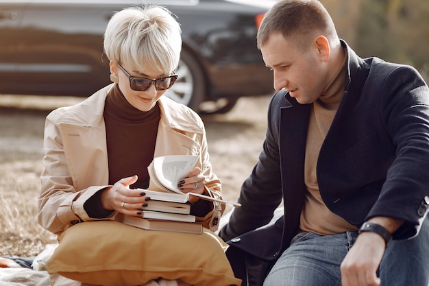 Beautiful couple spend time on a autumn field