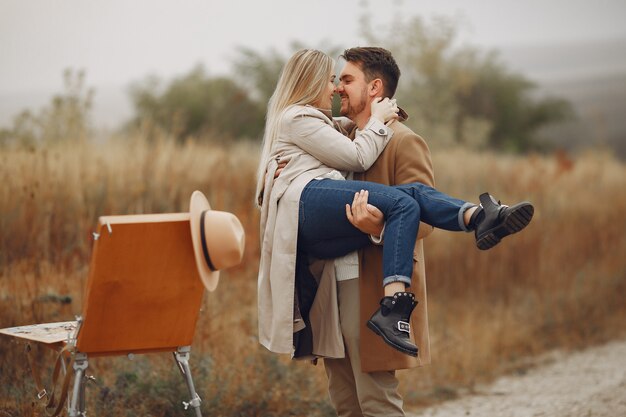 Beautiful couple spend time in a autumn field