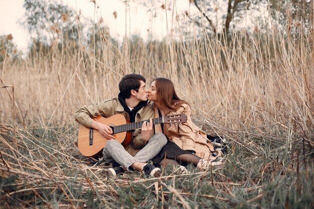 Beautiful couple spend time in an autumn field