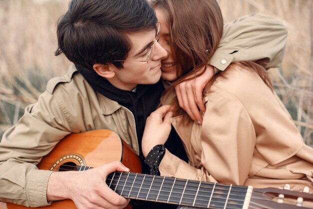 Beautiful couple spend time in an autumn field