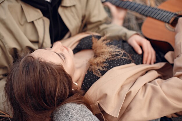 Beautiful couple spend time in an autumn field