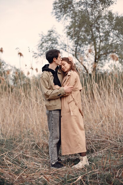 Beautiful couple spend time in an autumn field