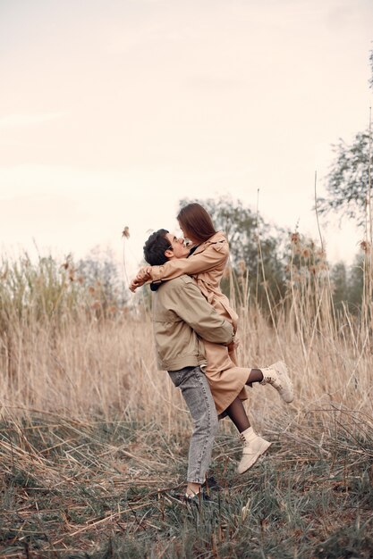 Beautiful couple spend time in an autumn field