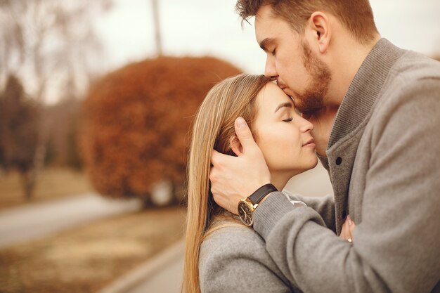 Beautiful couple spend time in a autumn park