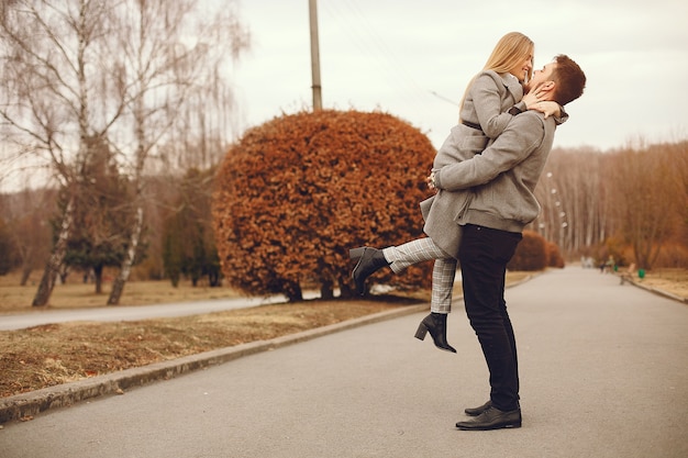 Beautiful couple spend time in a autumn park