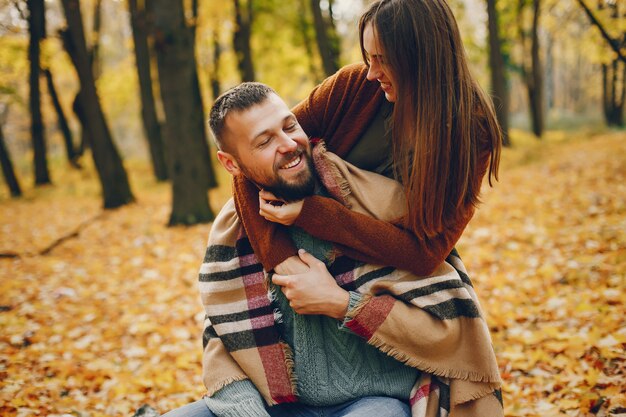 Beautiful couple spend time in a autumn park