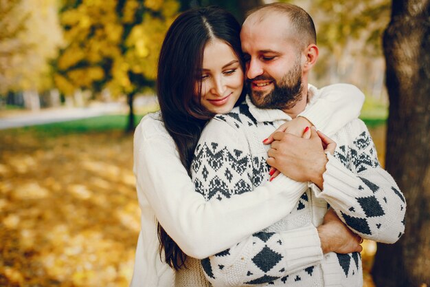 Beautiful couple spend time in a autumn park