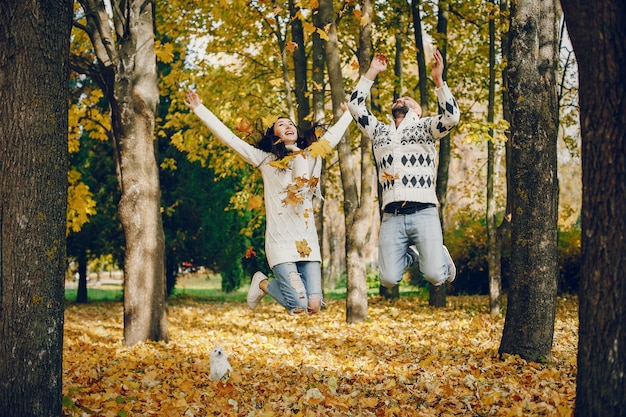 Beautiful couple spend time in a autumn park