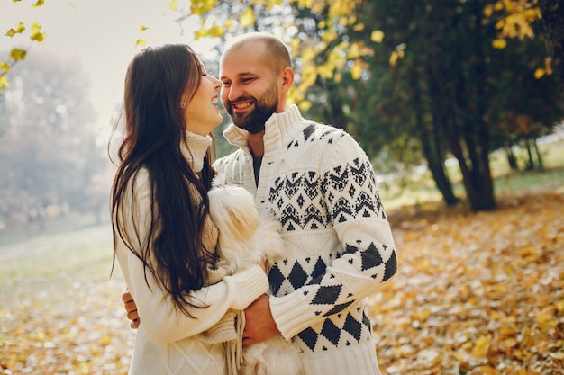 Beautiful couple spend time in a autumn park