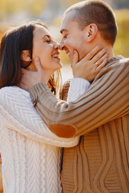 Beautiful couple spend time on a autumn park