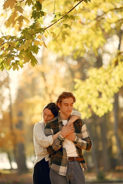 Beautiful couple spend time in a autumn park