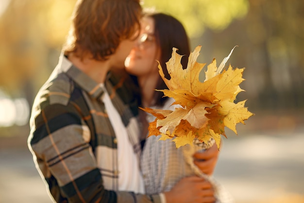 Free photo beautiful couple spend time in a autumn park