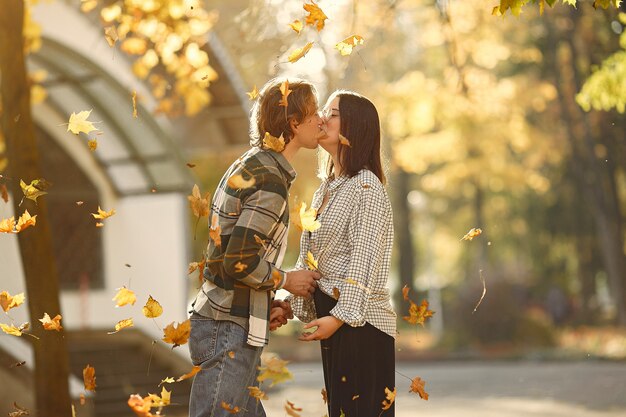 Beautiful couple spend time in a autumn park