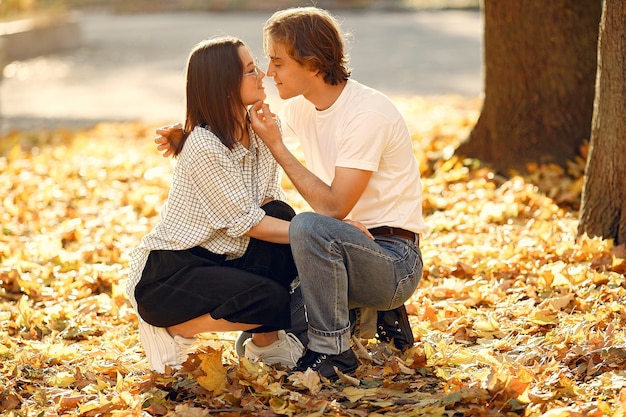 Beautiful couple spend time in a autumn park