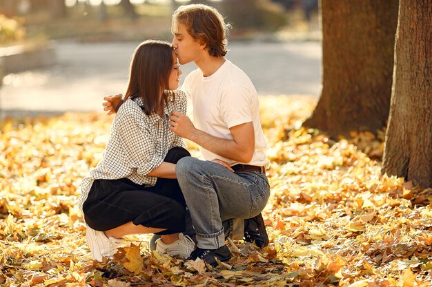 Beautiful couple spend time in a autumn park