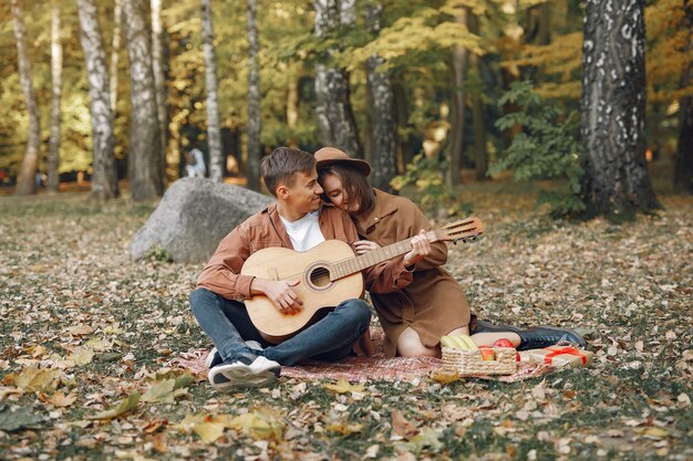 Beautiful couple spend time in a autumn park