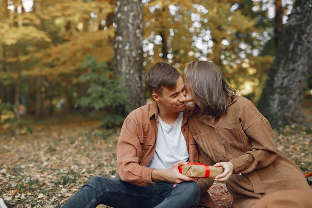 Beautiful couple spend time in a autumn park