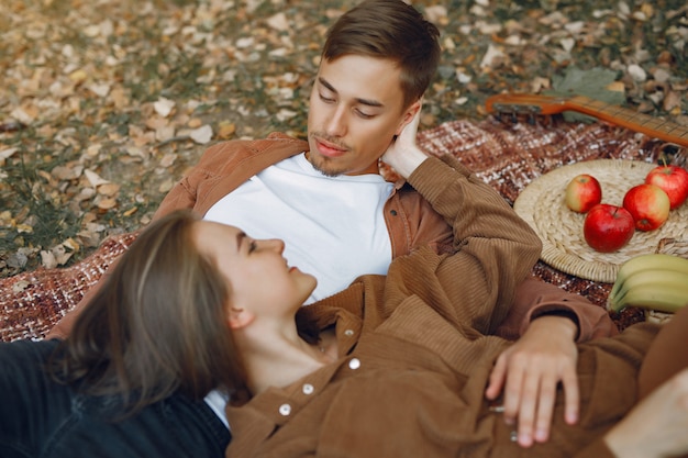 Beautiful couple spend time in a autumn park