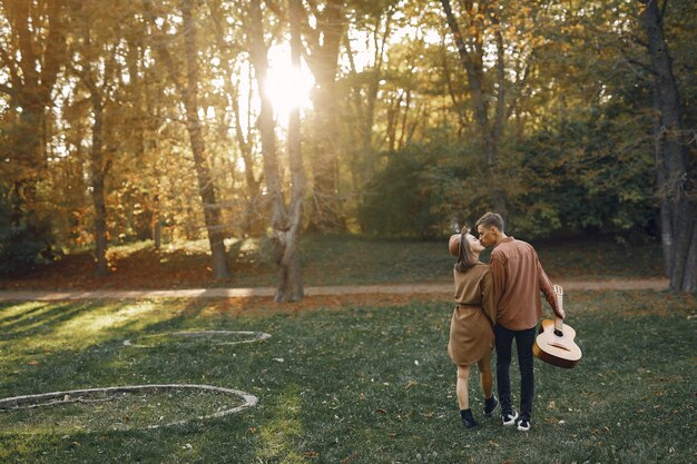 Beautiful couple spend time in a autumn park