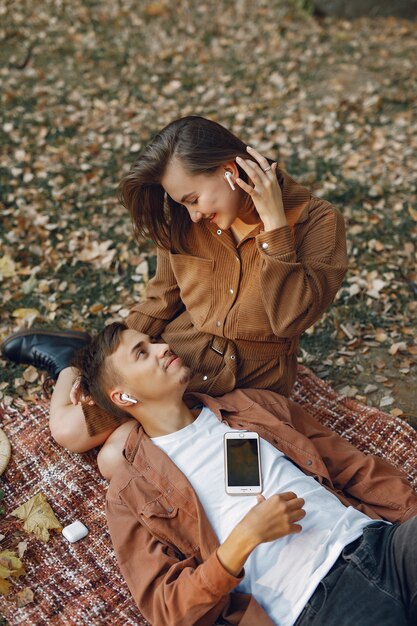 Beautiful couple spend time in a autumn park