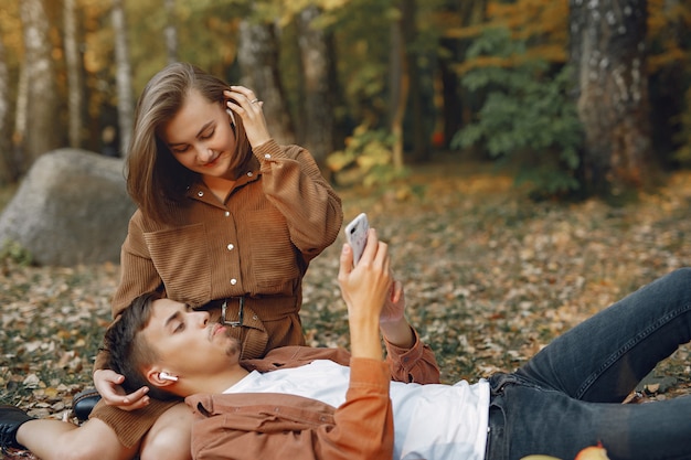 Beautiful couple spend time in a autumn park