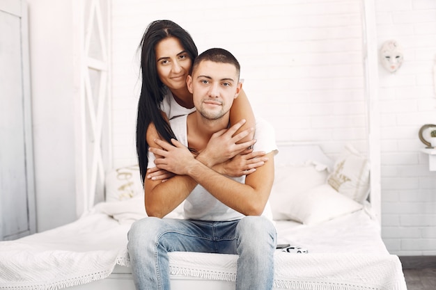 Beautiful couple spend time in a bedroom