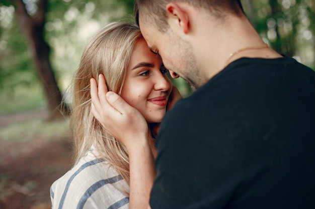 Free photo beautiful couple spend time on a forest