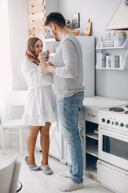 Beautiful couple spend time in a kitchen