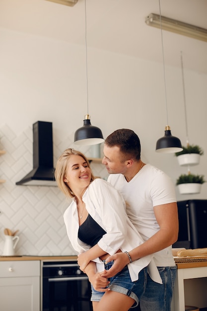 Free photo beautiful couple spend time in a kitchen