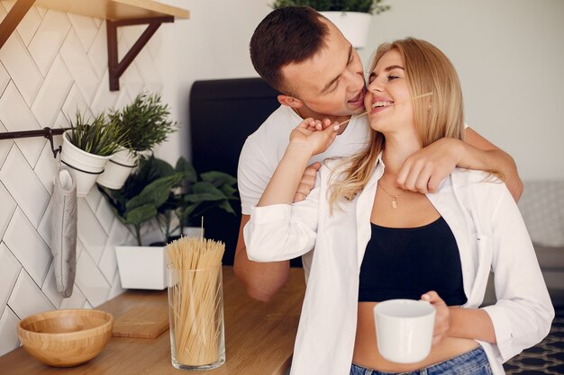 Beautiful couple spend time in a kitchen