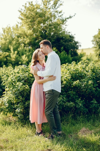 Beautiful couple spend time on a summer field