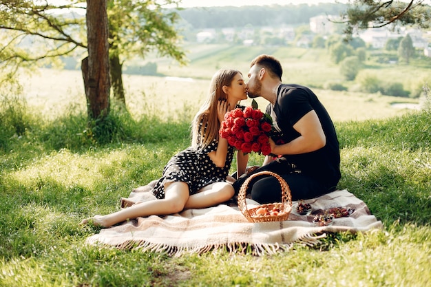 Beautiful couple spend time in a summer field