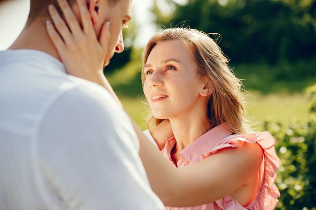 Beautiful couple spend time on a summer field