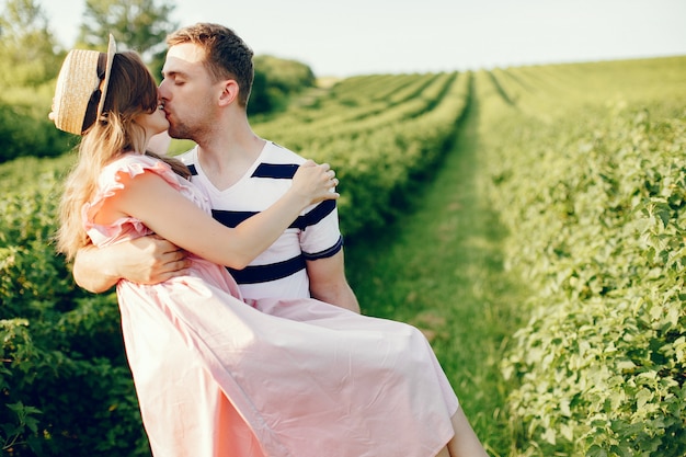 Beautiful couple spend time on a summer field