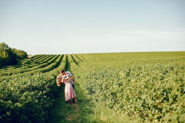 Beautiful couple spend time on a summer field