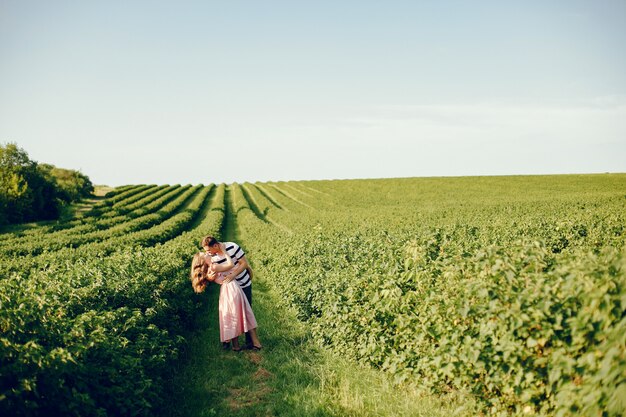 Beautiful couple spend time on a summer field