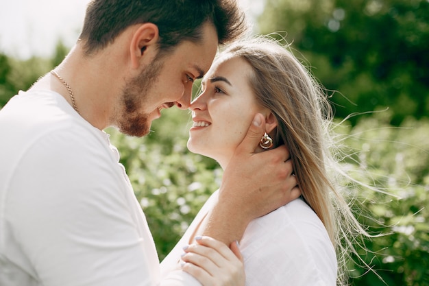 Beautiful couple spend time on a summer field