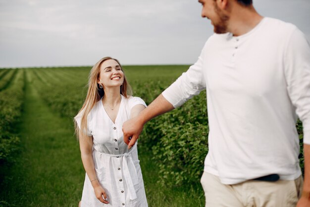 Beautiful couple spend time on a summer field