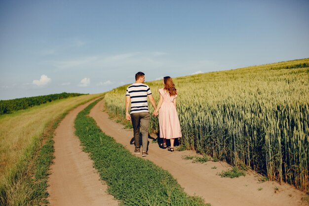 Beautiful couple spend time on a summer field