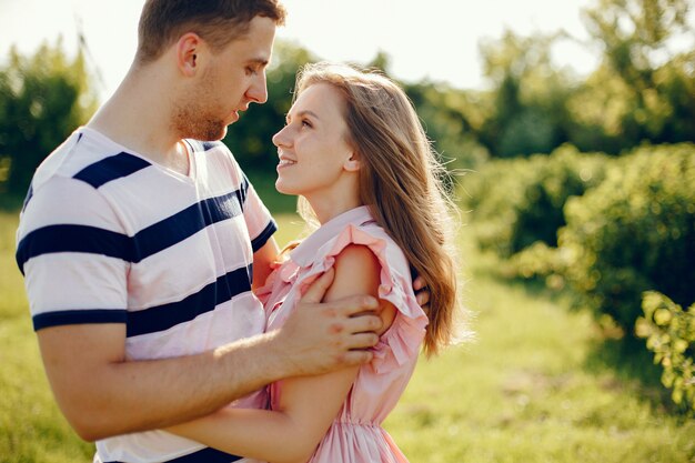 Beautiful couple spend time on a summer field